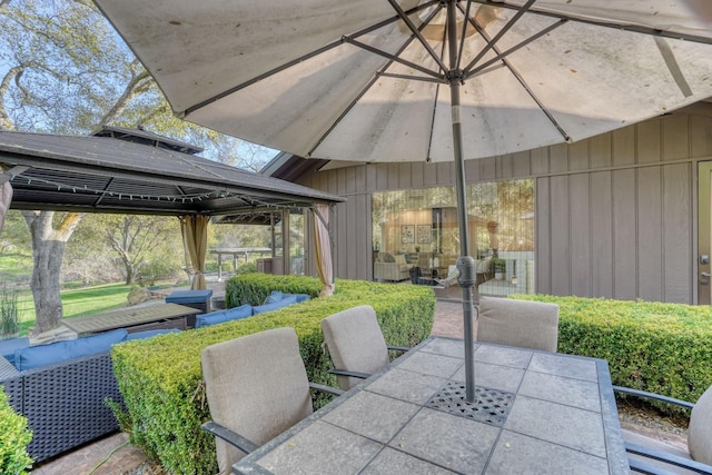 view of patio featuring a gazebo and outdoor dining space