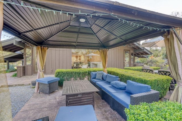 view of patio with an outdoor living space and a gazebo