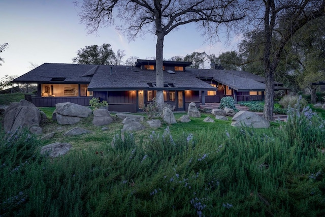 back of house at dusk with board and batten siding