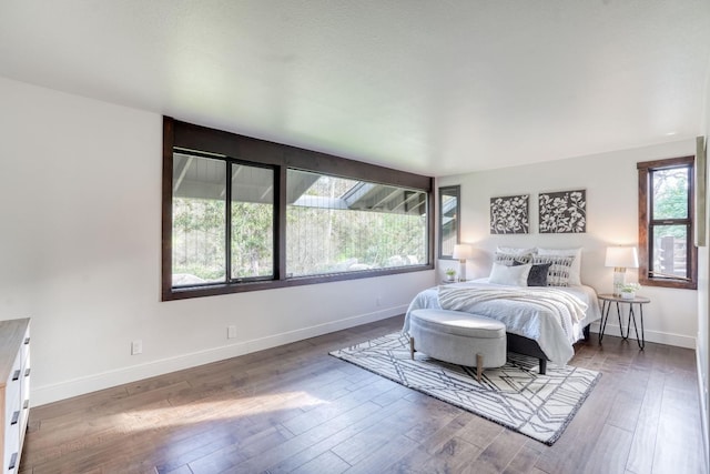 bedroom featuring hardwood / wood-style floors and baseboards