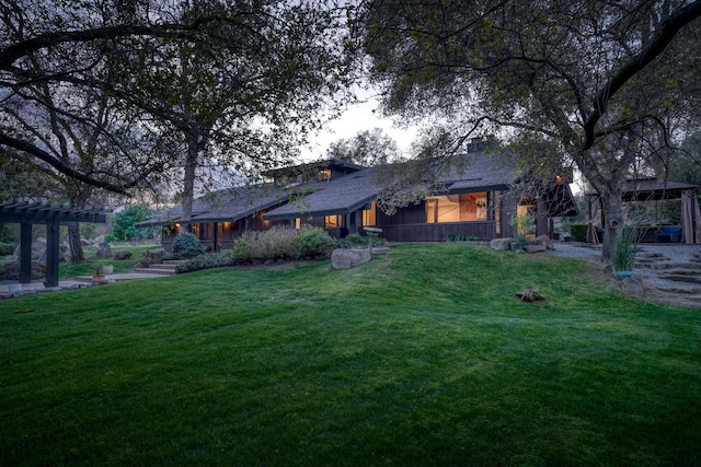 exterior space featuring a front yard and a pergola