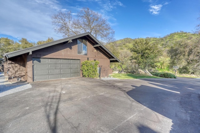 view of property exterior featuring a detached garage