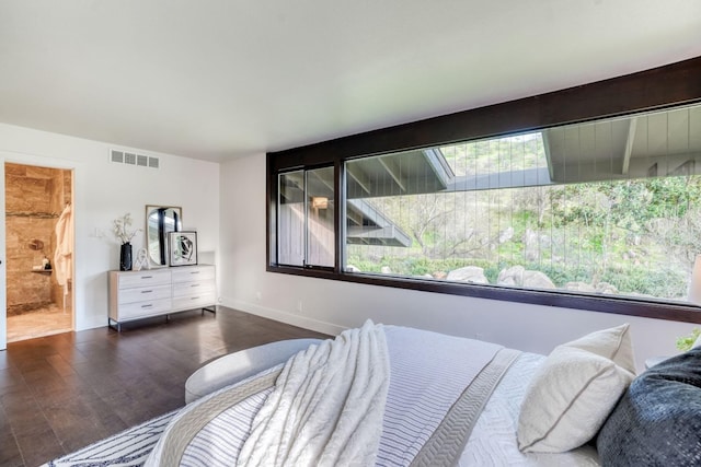 bedroom featuring visible vents, baseboards, and wood finished floors