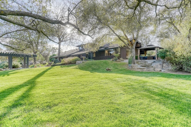 view of yard featuring a gazebo and a pergola