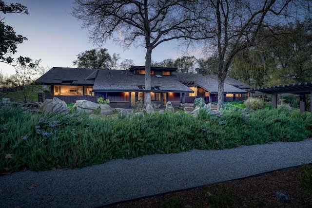 exterior space featuring a deck, board and batten siding, and a pergola