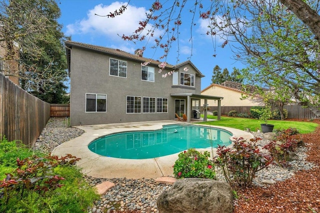 view of swimming pool featuring a yard, a fenced in pool, a fenced backyard, and a patio