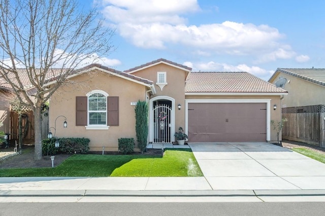 view of front facade with a garage, driveway, a tiled roof, fence, and stucco siding