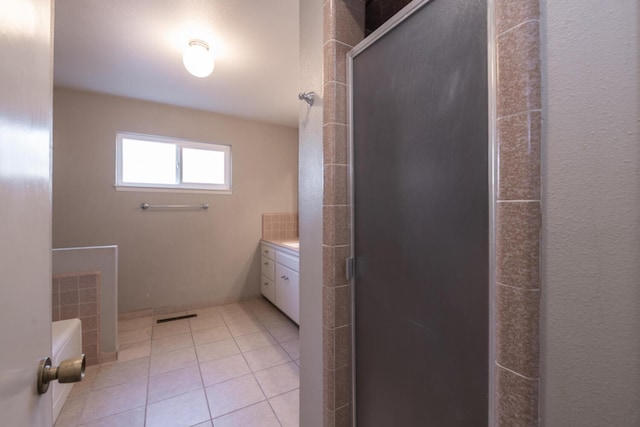 bathroom with vanity, a stall shower, tile patterned flooring, and visible vents