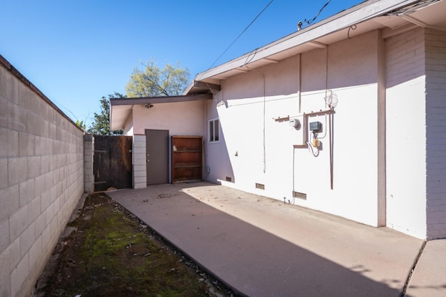 exterior space with crawl space, a patio area, and fence