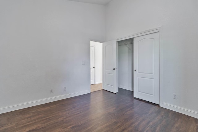 15877 W C St, Kerman, CA 93630 - unfurnished bedroom with dark wood-type flooring, a high ceiling, and a closet