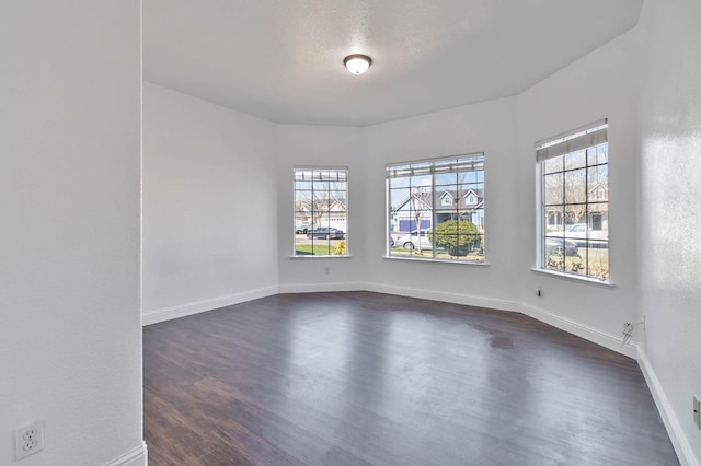 15877 W C St, Kerman, CA 93630 - spare room featuring plenty of natural light and dark wood-type flooring