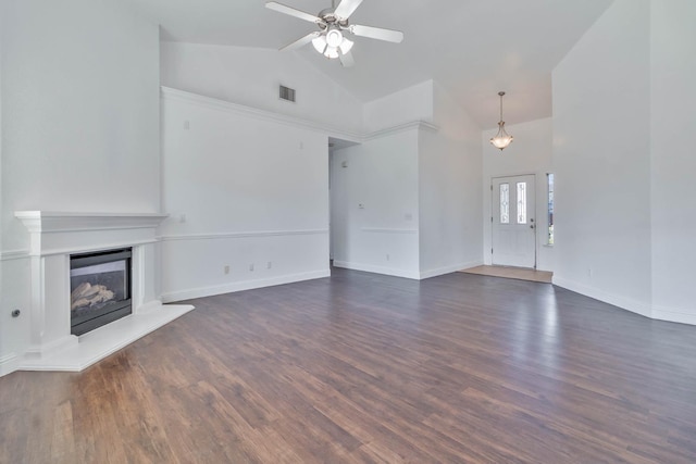 15877 W C St, Kerman, CA 93630 - unfurnished living room with high vaulted ceiling, a ceiling fan, a glass covered fireplace, and dark wood-style floors