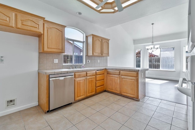 15877 W C St, Kerman, CA 93630 - kitchen with stainless steel dishwasher, a chandelier, backsplash, light tile patterned flooring, and a peninsula