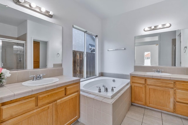 15877 W C St, Kerman, CA 93630 - full bathroom featuring two vanities, a shower stall, a garden tub, and tile patterned floors
