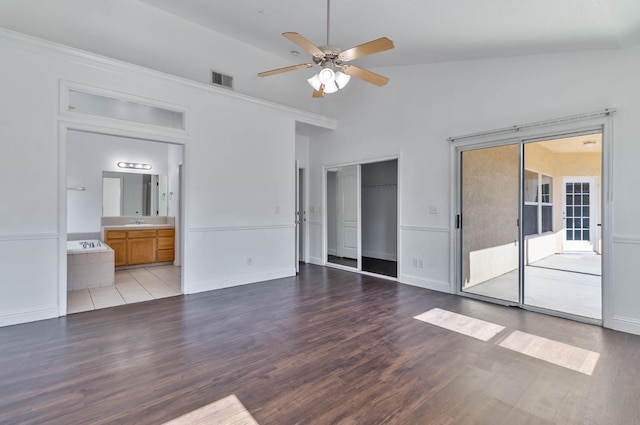 15877 W C St, Kerman, CA 93630 - unfurnished bedroom featuring wood finished floors, a ceiling fan, and ensuite bath