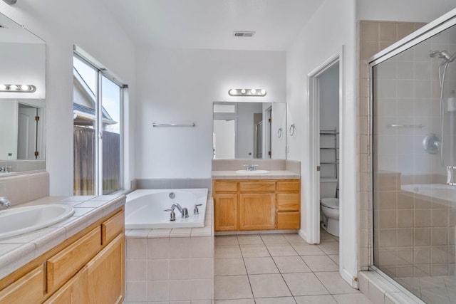 15877 W C St, Kerman, CA 93630 - bathroom featuring a stall shower, two vanities, a garden tub, and tile patterned flooring