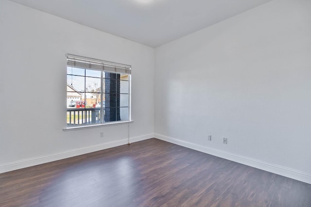 15877 W C St, Kerman, CA 93630 - spare room with dark wood-style floors and baseboards