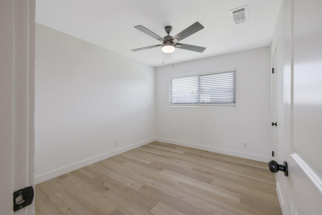 empty room with light wood-style floors, baseboards, visible vents, and a ceiling fan