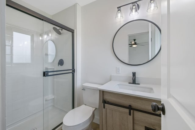 bathroom featuring a stall shower, vanity, and toilet