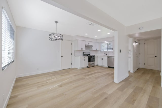 unfurnished living room with recessed lighting, a sink, visible vents, baseboards, and light wood finished floors