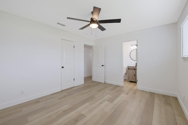 unfurnished bedroom featuring light wood-style floors, visible vents, and baseboards