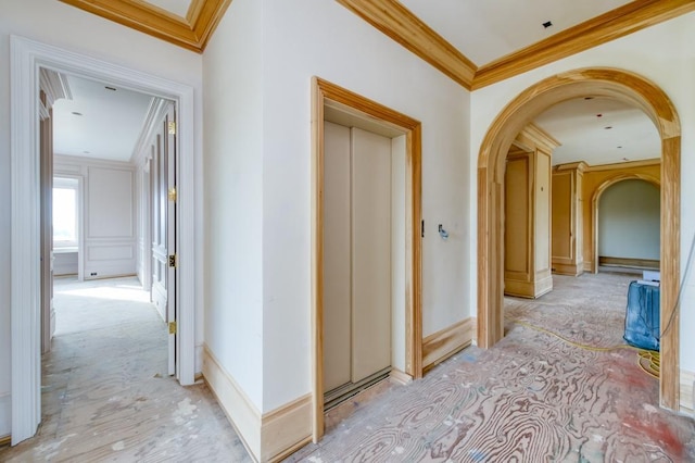 hall with arched walkways, crown molding, and baseboards