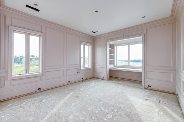 empty room featuring plenty of natural light and a decorative wall