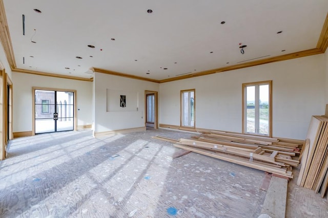 empty room featuring ornamental molding and baseboards