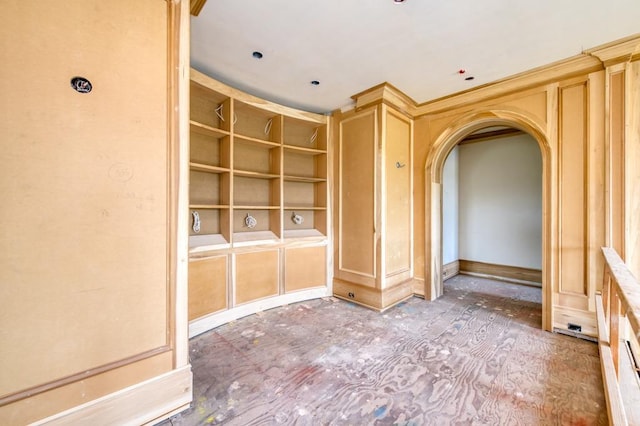 unfurnished room with arched walkways