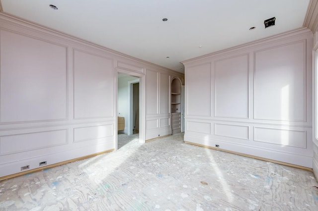 unfurnished bedroom with a decorative wall and crown molding