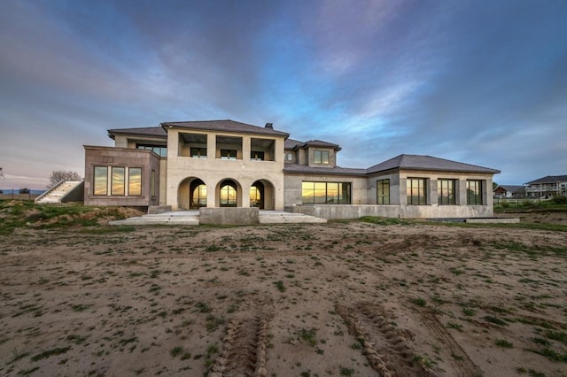 view of back of house at dusk