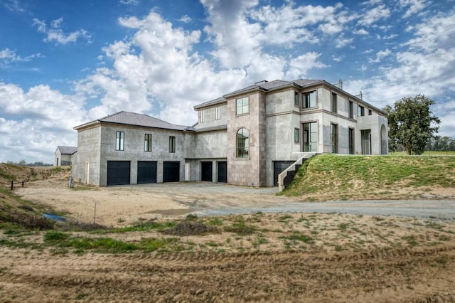 view of side of home with driveway and an attached garage