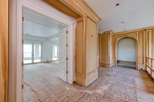 corridor featuring ornamental molding and arched walkways