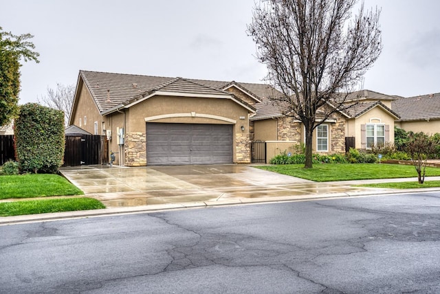 ranch-style home with stucco siding, an attached garage, a gate, fence, and stone siding