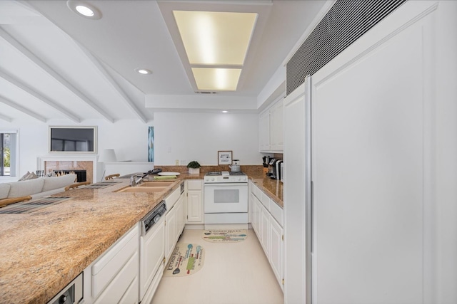 39118 Lake Dr, Bass Lake, CA 93604 - kitchen with white range, dishwasher, paneled refrigerator, white cabinetry, and a fireplace