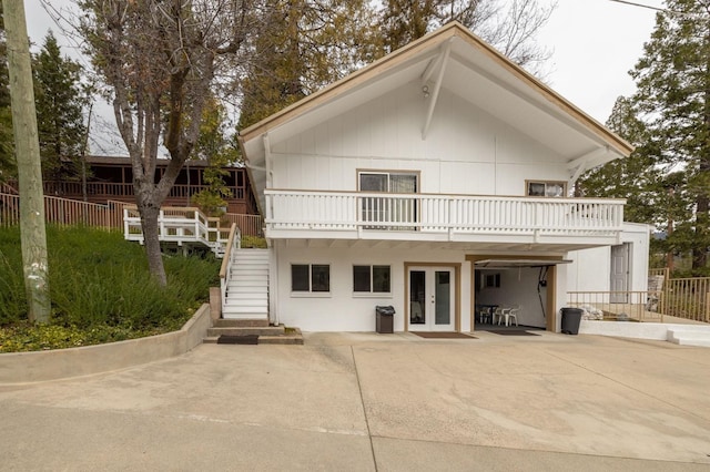 39118 Lake Dr, Bass Lake, CA 93604 - view of front of house featuring french doors, stairway, and a patio