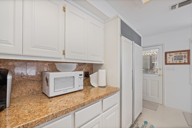 39118 Lake Dr, Bass Lake, CA 93604 - kitchen with white microwave, tasteful backsplash, and white cabinetry