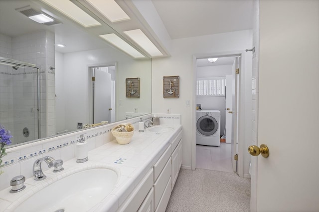 39118 Lake Dr, Bass Lake, CA 93604 - bathroom with washer / clothes dryer, a shower stall, and double vanity
