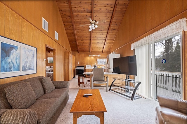 39118 Lake Dr, Bass Lake, CA 93604 - living area with high vaulted ceiling, light colored carpet, wood walls, wood ceiling, and ceiling fan