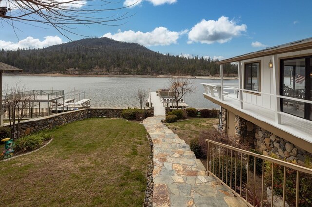 39118 Lake Dr, Bass Lake, CA 93604 - dock featuring a water and mountain view, a view of trees, a yard, and boat lift