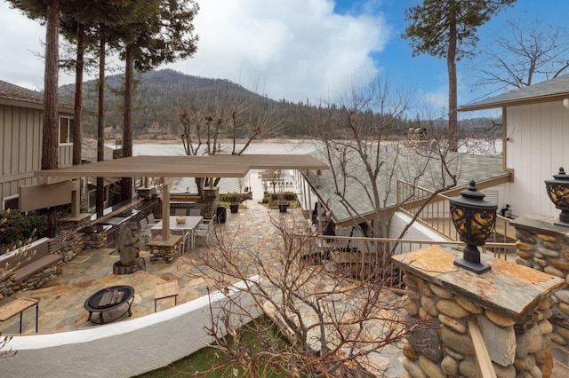 39118 Lake Dr, Bass Lake, CA 93604 - view of patio featuring a fire pit and a mountain view