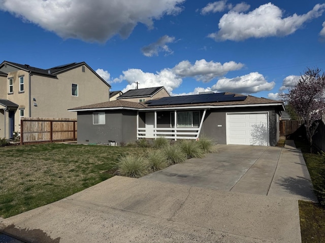 view of front of property with a front lawn, fence, stucco siding, a garage, and driveway