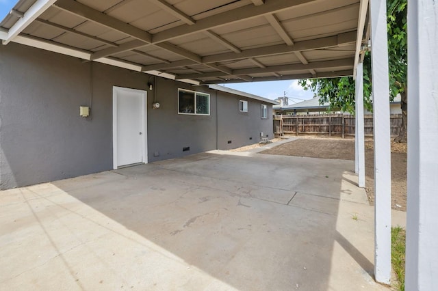 view of patio / terrace featuring a carport and fence