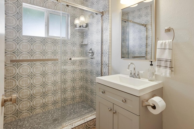 bathroom with vanity and tiled shower