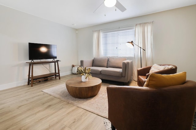 living room with wood finished floors, baseboards, and ceiling fan