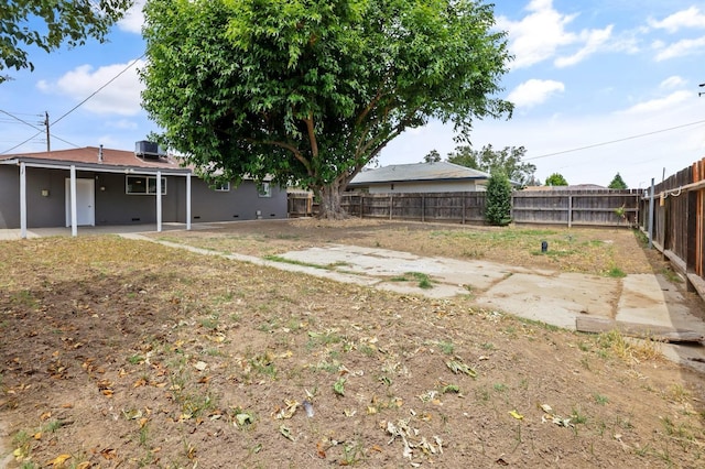 view of yard featuring a patio area and a fenced backyard