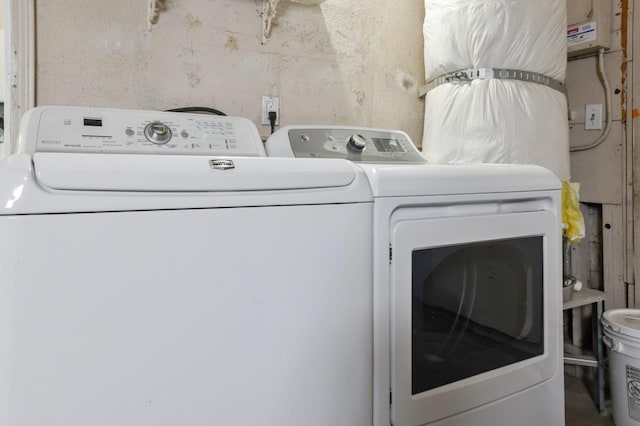 washroom with washing machine and clothes dryer and laundry area