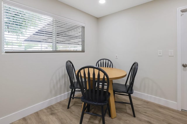 dining space with wood finished floors and baseboards