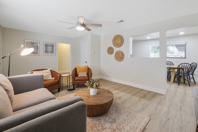 living area featuring visible vents, ceiling fan, baseboards, recessed lighting, and light wood-style floors