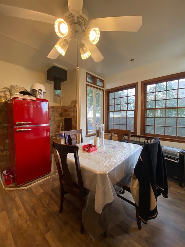 dining space with wood finished floors and a ceiling fan